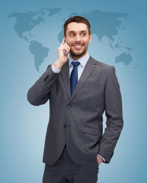 Young smiling businessman with smartphone — Stock Photo, Image