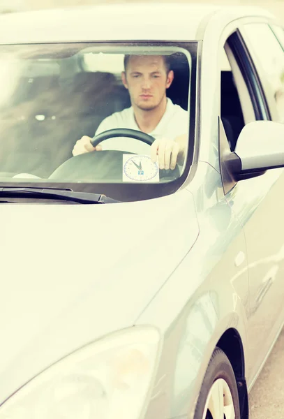 Man placing parking clock on car dashboard — Stock Photo, Image