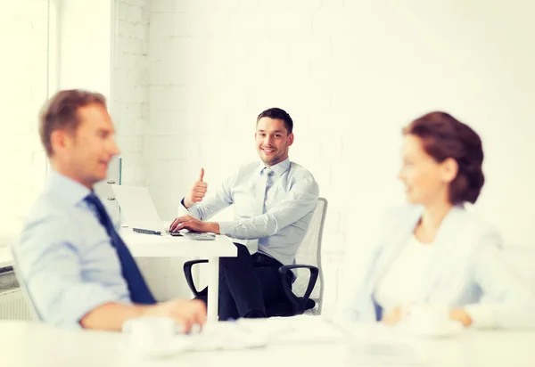 Happy businessman showing thumbs up in office — Stock Photo, Image