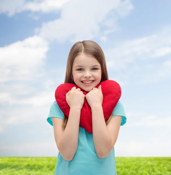 Sorrindo menina com coração vermelho — Fotografia de Stock