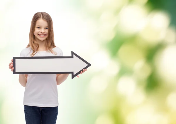 Smiling girl with blank arrow pointing right — Stock Photo, Image