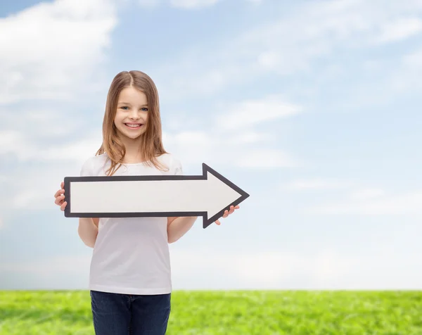 Smiling girl with blank arrow pointing right — Stock Photo, Image