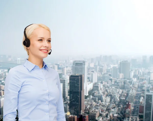 Friendly female helpline operator with headphones — Stock Photo, Image