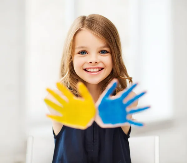 Girl showing painted hands Stock Photo