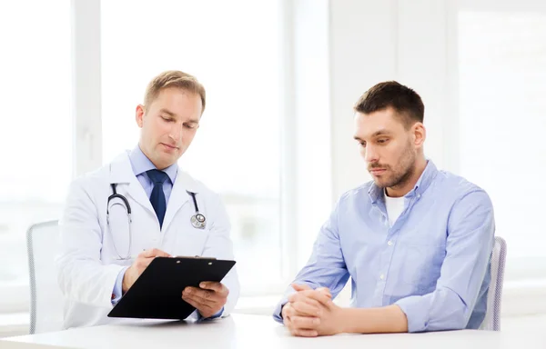 Doctor with clipboard and patient in hospital — Stock Photo, Image