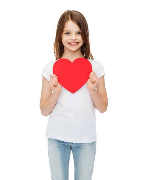 Smiling little girl with red heart — Stock Photo, Image