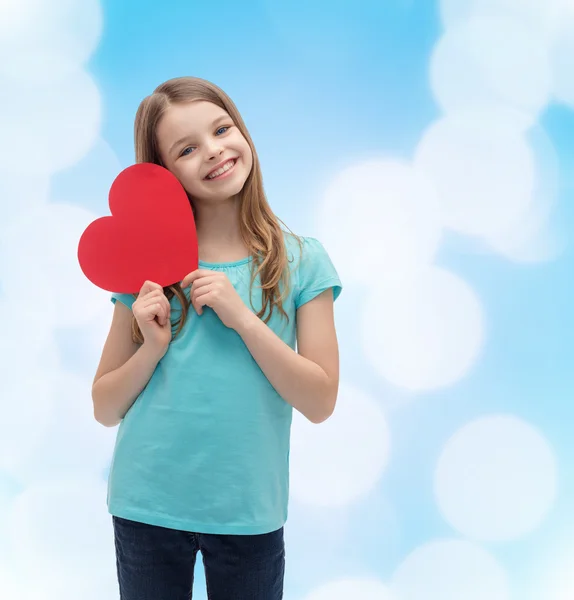 Smiling little girl with red heart — Stock Photo, Image