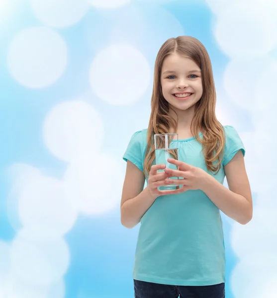Smiling little girl with glass of water — Stock Photo, Image
