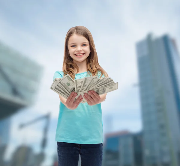 Smiling little girl giving dollar cash money — Stock Photo, Image