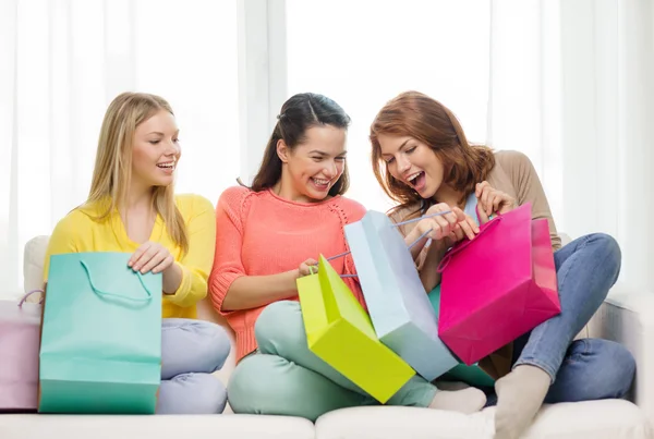 Smiling teenage girls with many shopping bags — Stock Photo, Image