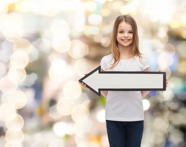 Smiling girl with blank arrow pointing left — Stock Photo, Image