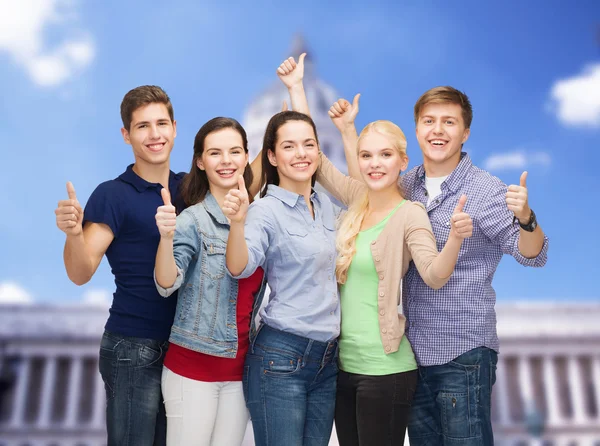 Grupp leende studenter visar tummen — Stockfoto