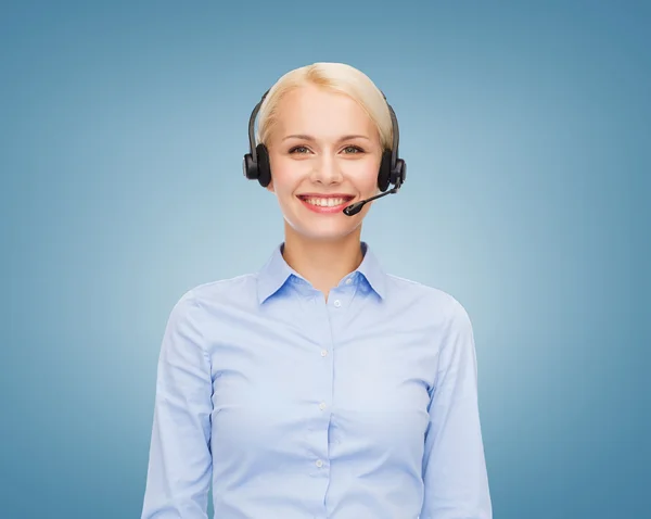 Friendly female helpline operator with headphones — Stock Photo, Image