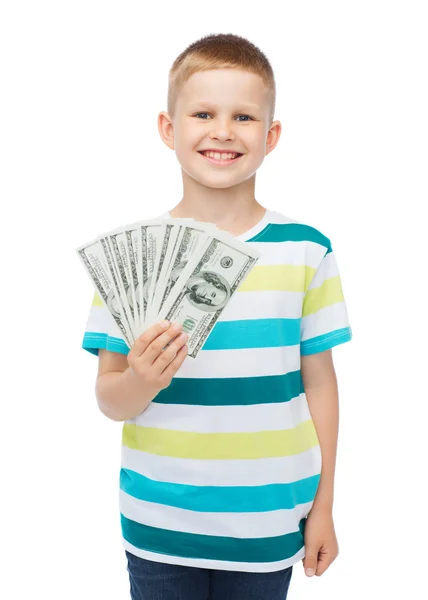 Sorrindo menino segurando dinheiro em dinheiro dólar em sua mão — Fotografia de Stock