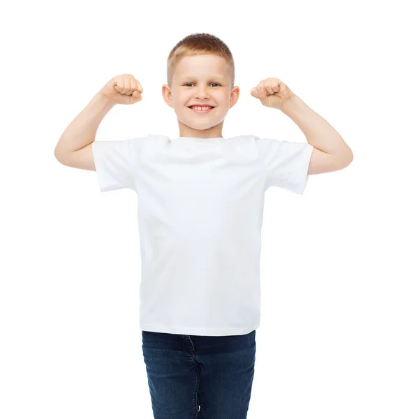 Little boy in blank white t-shirt showing muscles — Stock Photo, Image