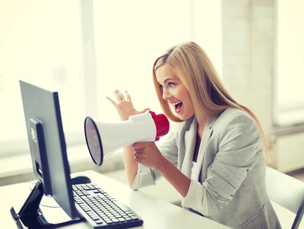 Crazy businesswoman shouting in megaphone — Stock Photo, Image