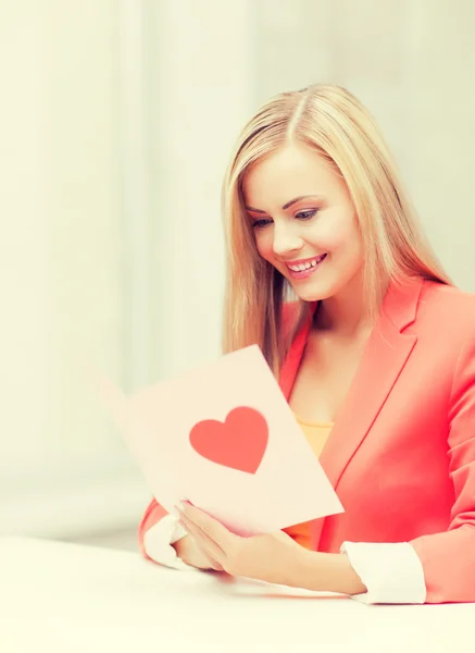 Woman holding postcard with heart shape — Stock Photo, Image