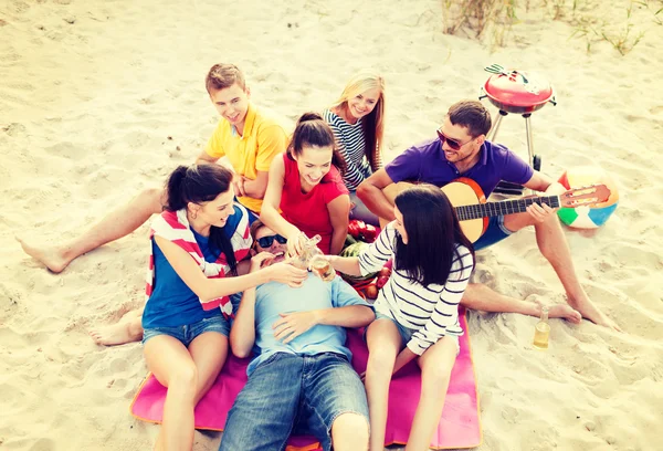 Gruppe von Freunden mit Gitarre amüsiert sich am Strand — Stockfoto