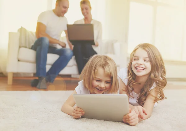 Lachende zus met tablet pc en ouders op rug — Stockfoto