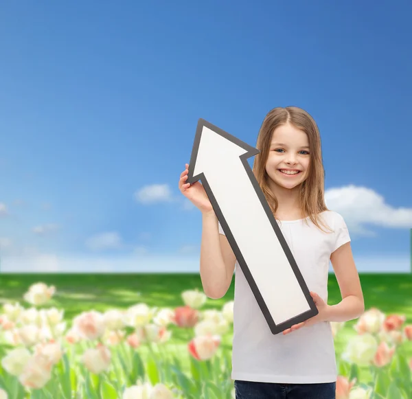 Smiling little girl with blank arrow pointing up — Stock Photo, Image