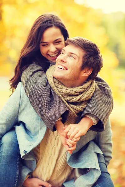 Romantic couple playing in the autumn park — Stock Photo, Image