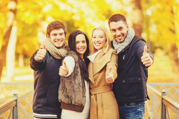 Group of friends having fun in autumn park — Stock Photo, Image