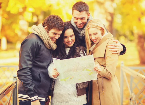 Parejas con mapa turístico en el parque de otoño —  Fotos de Stock