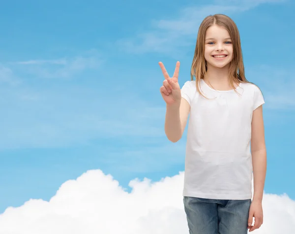 Little girl in white t-shirt showing peace gesture — Stock Photo, Image