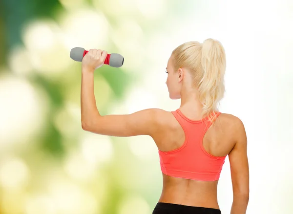 Young sporty woman with light dumbbell — Stock Photo, Image