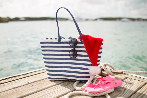 Close up of beach accessories and santa helper hat — Stock Photo, Image