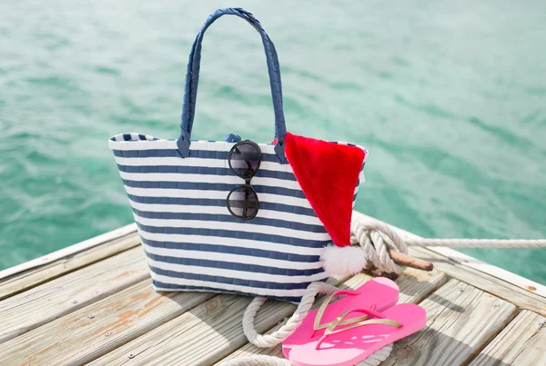 Close up of beach accessories and santa helper hat — Stock Photo, Image