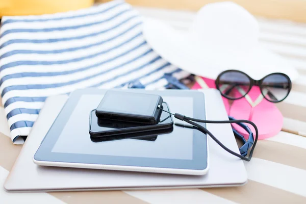 Close up of tablet pc and smartphone on beach — Stock Photo, Image