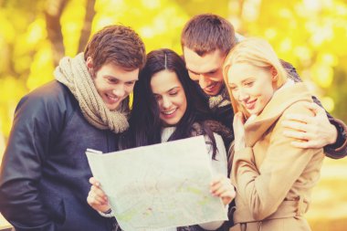 couples with tourist map in autumn park clipart