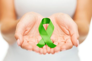 hands holding green awareness ribbon clipart
