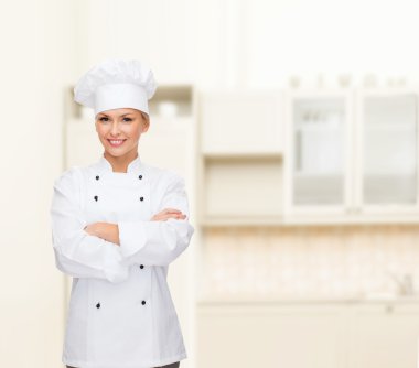 smiling female chef with crossed arms clipart