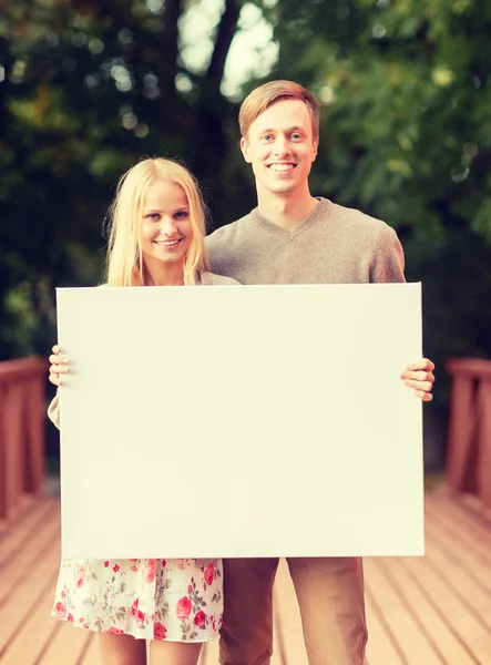 Romantic couple with blank white board — Stock Photo, Image