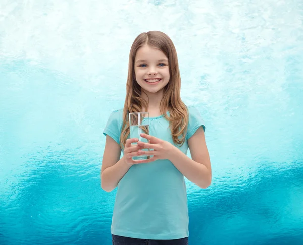 Smiling little girl with glass of water — Stock Photo, Image