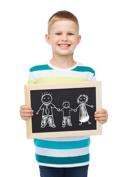 Smiling little boy holding chalkboard with family — Stock Photo, Image