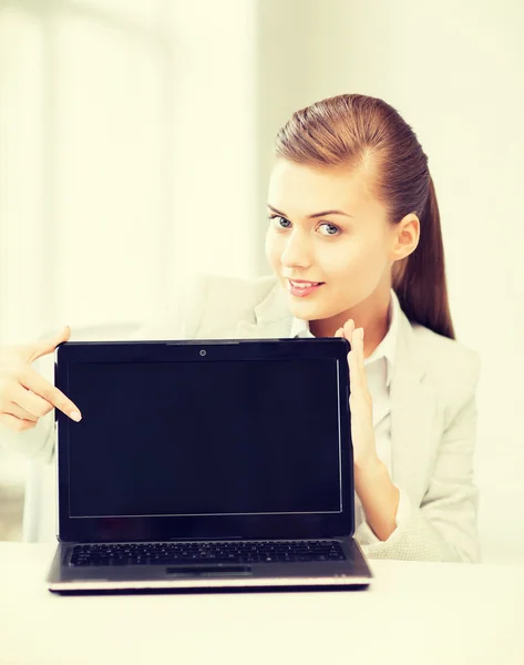 Businesswoman with laptop in office — Stock Photo, Image