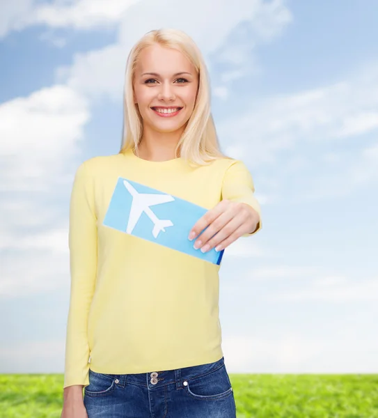 Smiling young woman with airplane ticket — Stock Photo, Image