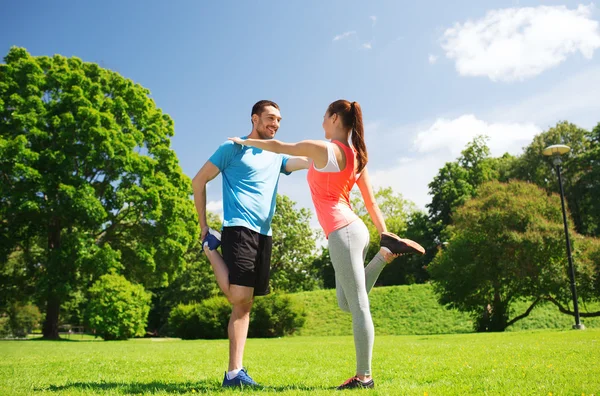 Smiling couple stretching outdoors Royalty Free Stock Images