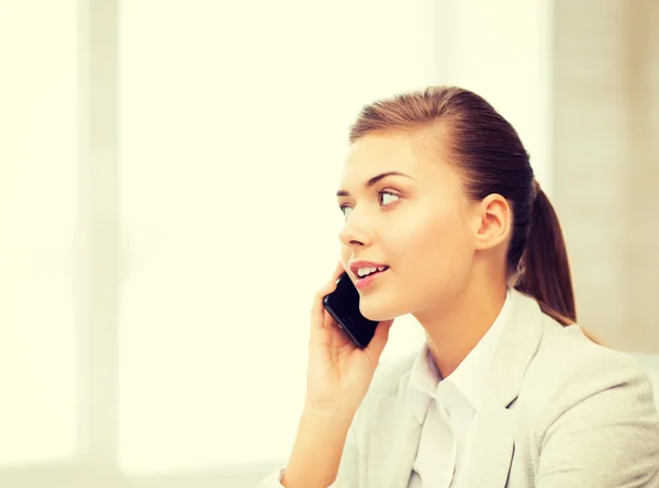 Businesswoman with smartphone in office — Stock Photo, Image