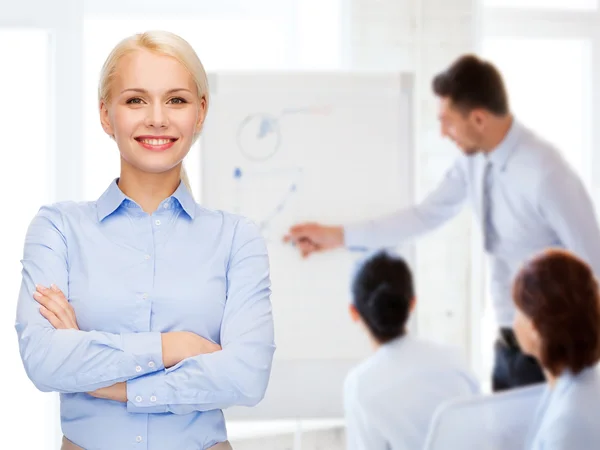 Young smiling businesswoman with crossed arms — Stock Photo, Image