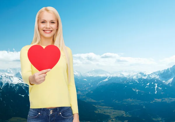 Smiling woman with red heart — Stock Photo, Image