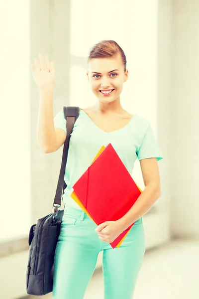 Student with folders and school bag in college — Stock Photo, Image