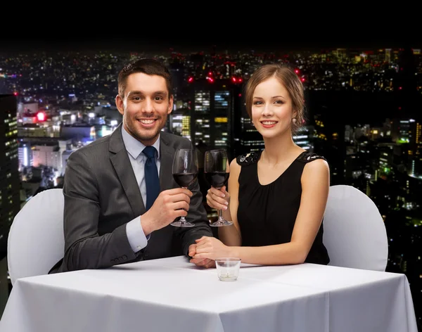 Jovem casal com copos de vinho no restaurante — Fotografia de Stock