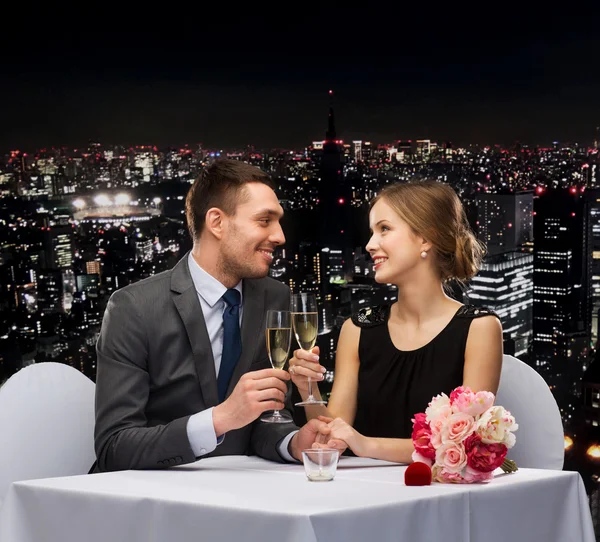 Couple with glasses of champagne at restaurant — Stock Photo, Image