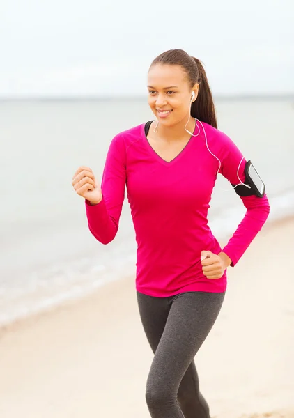 Sorridente giovane donna che corre all'aperto — Foto Stock