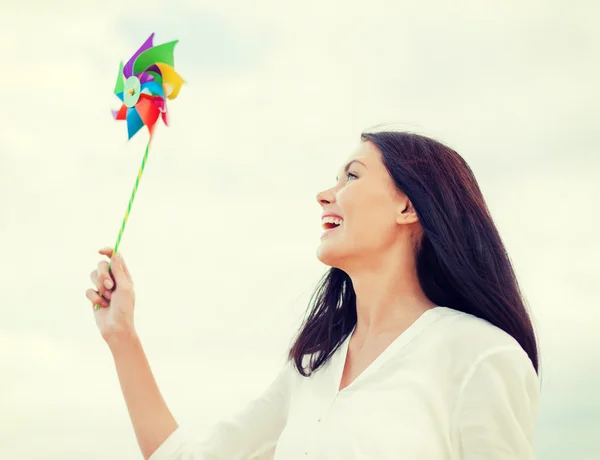 Girl with windmill toy on the beach — Stock Photo, Image