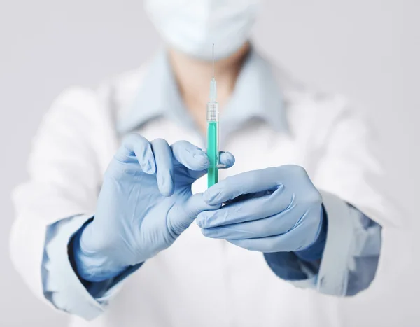 Female doctor holding syringe with injection — Stock Photo, Image